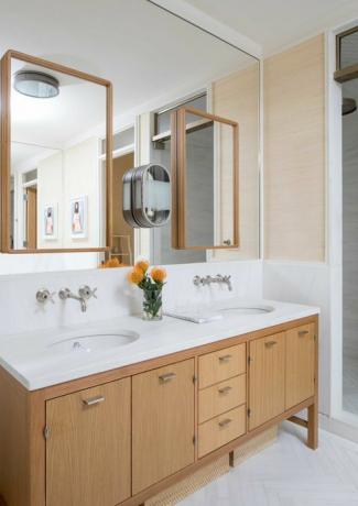 armários de banheiro de madeira, bancadas de mármore branco, pias duplas
