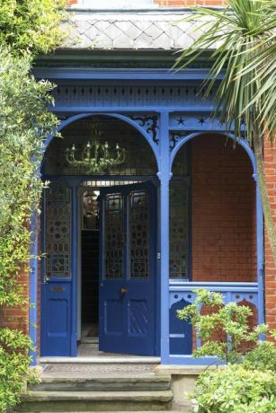 mėlynos priekinės durys ir veranda