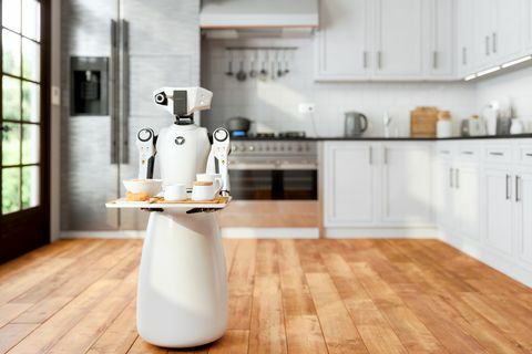 Robotermädchen, das ein Tablett hält und Speisen und Getränke in der modernen Haushaltsküche mit unscharfem Hintergrund serviert