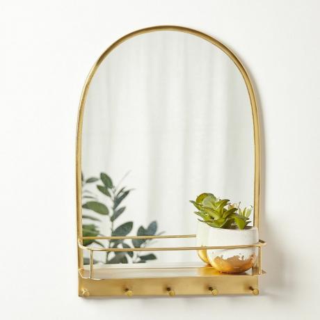 Specchio ad arco in metallo dorato con mensola e ganci