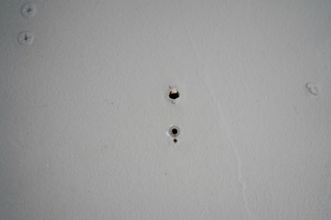 एक दीवार में छोटे ड्रिल छेद