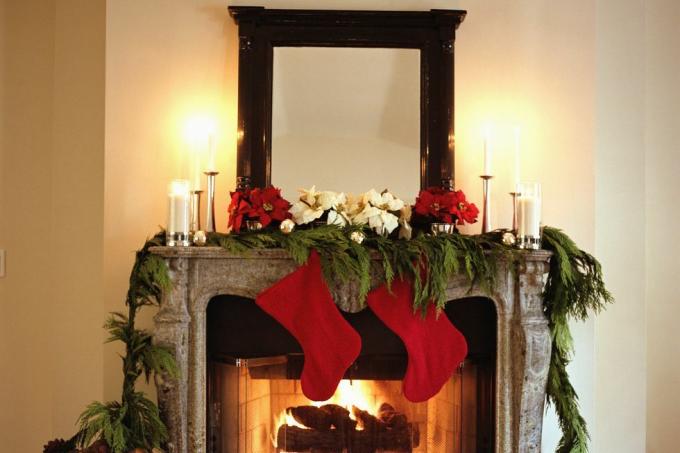 cheminée décorée de bas de Noël et de poinsettias