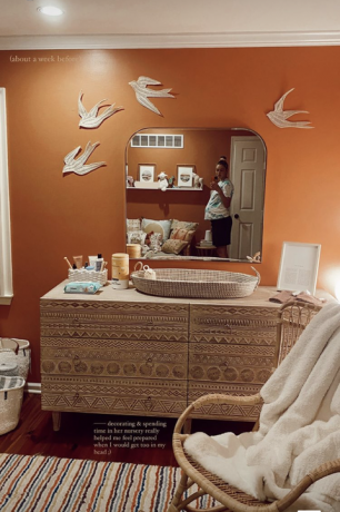 جدار برتقالي محترق مع خزانة أزتيك ، سلة ، مرآة ، حمام على الحائط
