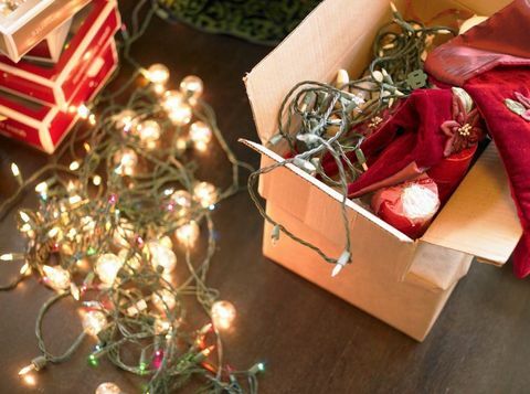 फर्श पर बक्सों में क्रिसमस रोशनी