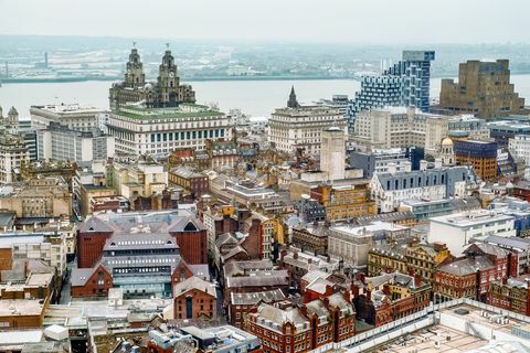 vyvýšený pohľad na ikonickú panorámu Liverpoolu z vnútrozemia s výhľadom na more, čas západu slnka, východný wirral v diaľke vrátane dokov Birkenhead, seacombe, budovy kráľovskej pečene, troch milostí a wallasey3. november 2015